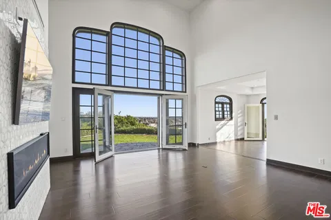 a view of an entryway with wooden floor