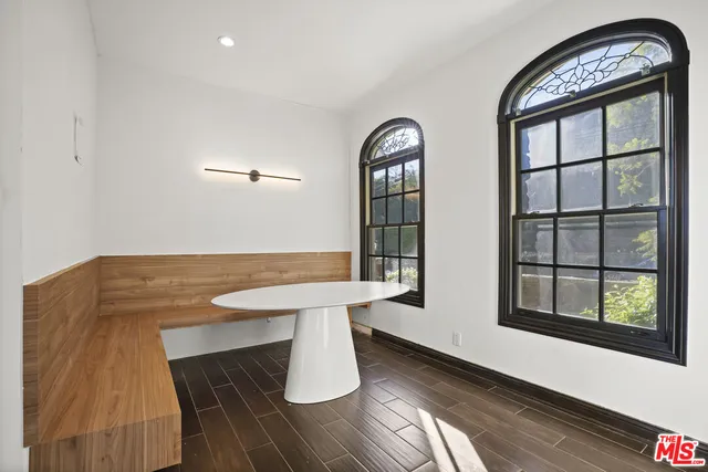 a view of a room with a window and wooden floor