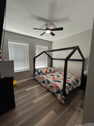 a bedroom with bed and a window