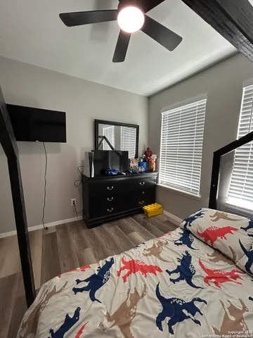 a bedroom with bed and a window