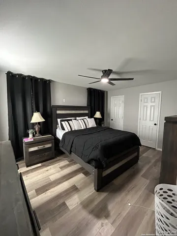 a bedroom with a bed and wooden floor