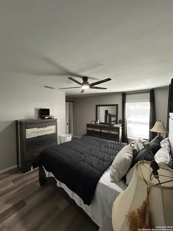 a bedroom with furniture and a window