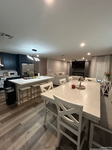 a large kitchen with a table and chairs