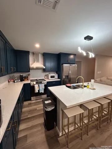 a large kitchen with a table and chairs