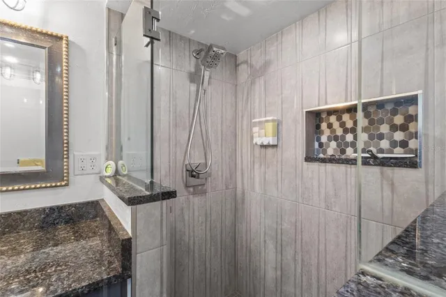 a bathroom with a shower and a sink