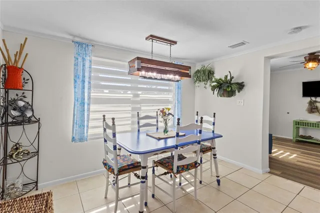 a kitchen with a refrigerator a stove a sink and white cabinets with wooden floor