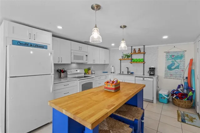 a kitchen with a sink a stove and cabinets