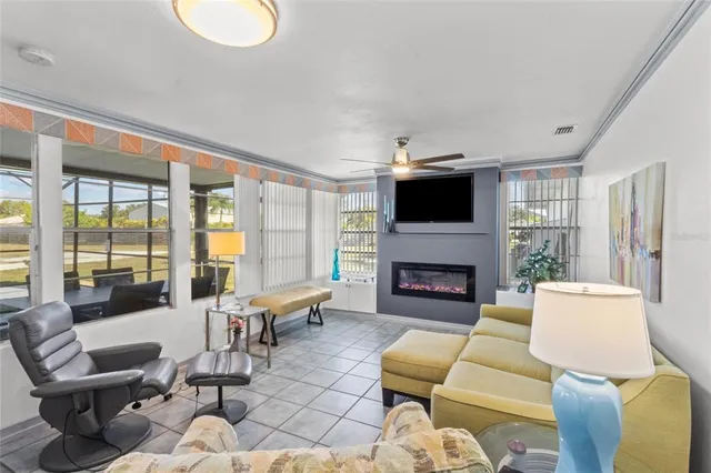 a living room with furniture a fireplace and a large window