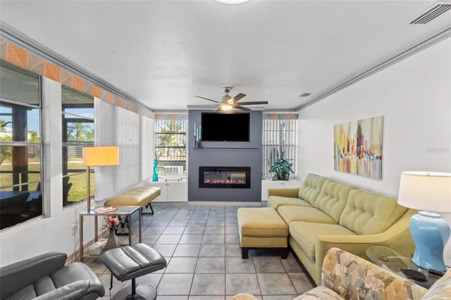 a living room with furniture a fireplace and a flat screen tv