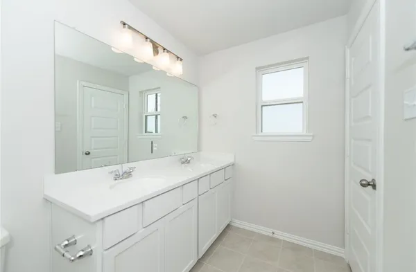a utility room with cabinets washer and dryer