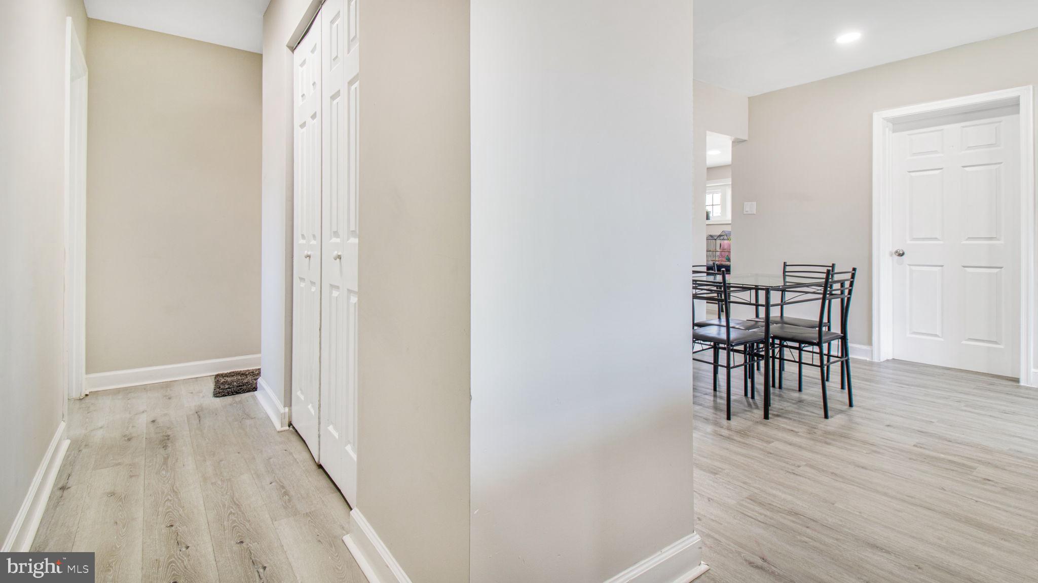 7600 Greenleaf Road Hyattsville, MD 20785 - Photo 13 of 42 a view of a hallway with wooden floor table and chairs