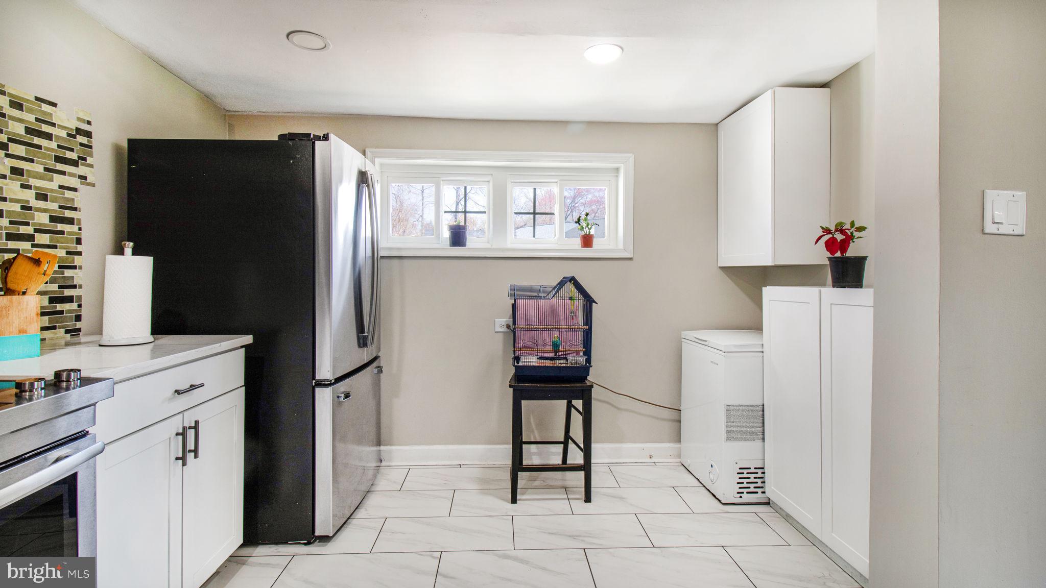 7600 Greenleaf Road Hyattsville, MD 20785 - Photo 15 of 42 a kitchen with stainless steel appliances a refrigerator and a stove top oven
