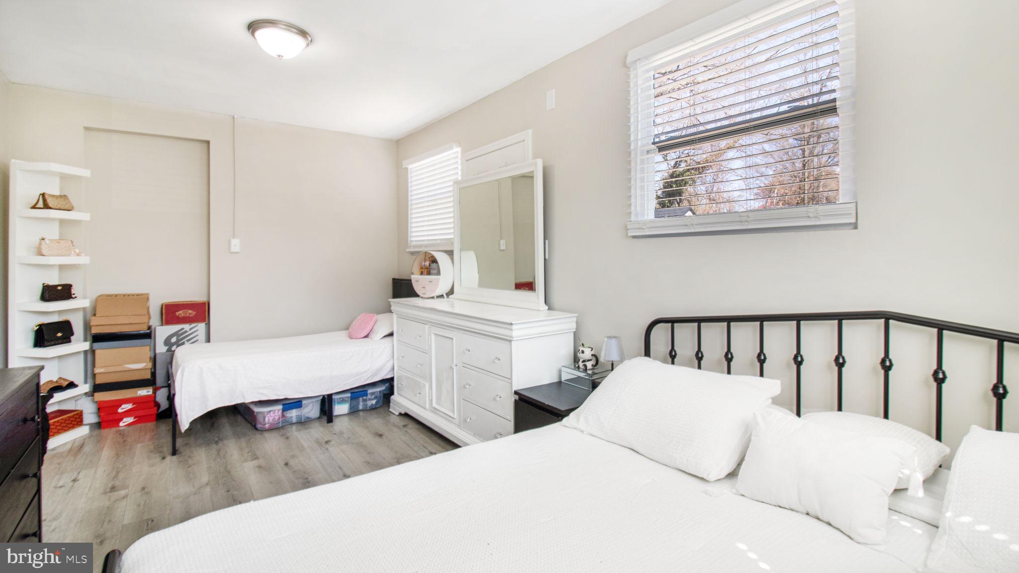 7600 Greenleaf Road Hyattsville, MD 20785 - Photo 19 of 42 a bedroom with two beds and a window