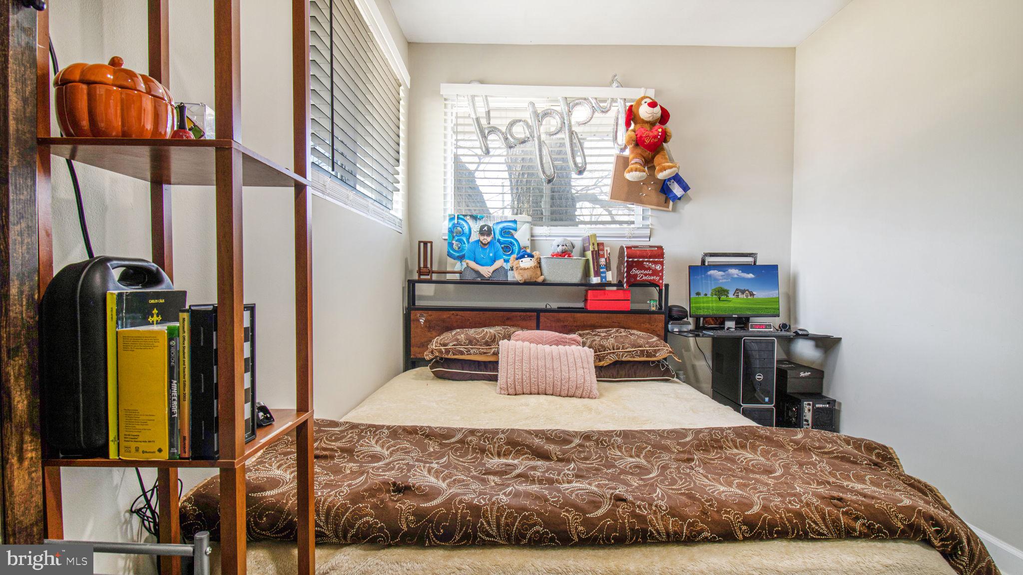 7600 Greenleaf Road Hyattsville, MD 20785 - Photo 20 of 42 a bedroom with a bed a dresser and next to a window