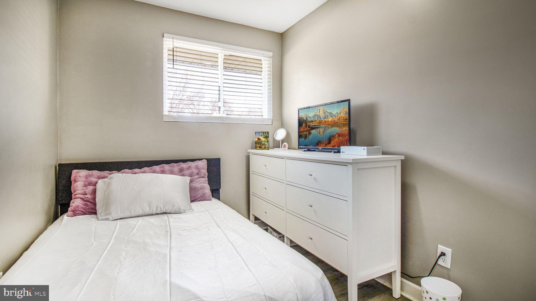 7600 Greenleaf Road Hyattsville, MD 20785 - Photo 26 of 42 a bedroom with a bed and a dresser