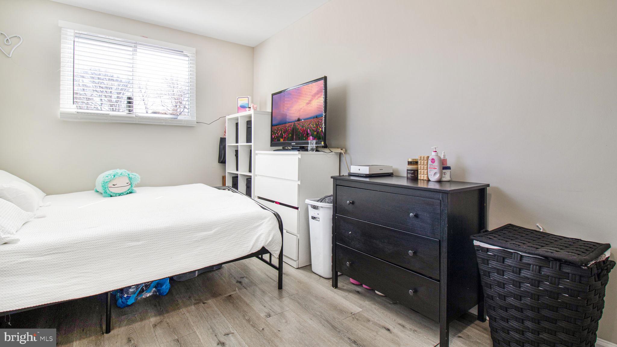 7600 Greenleaf Road Hyattsville, MD 20785 - Photo 29 of 42 a bedroom with a bed and flat tv screen on the dresser
