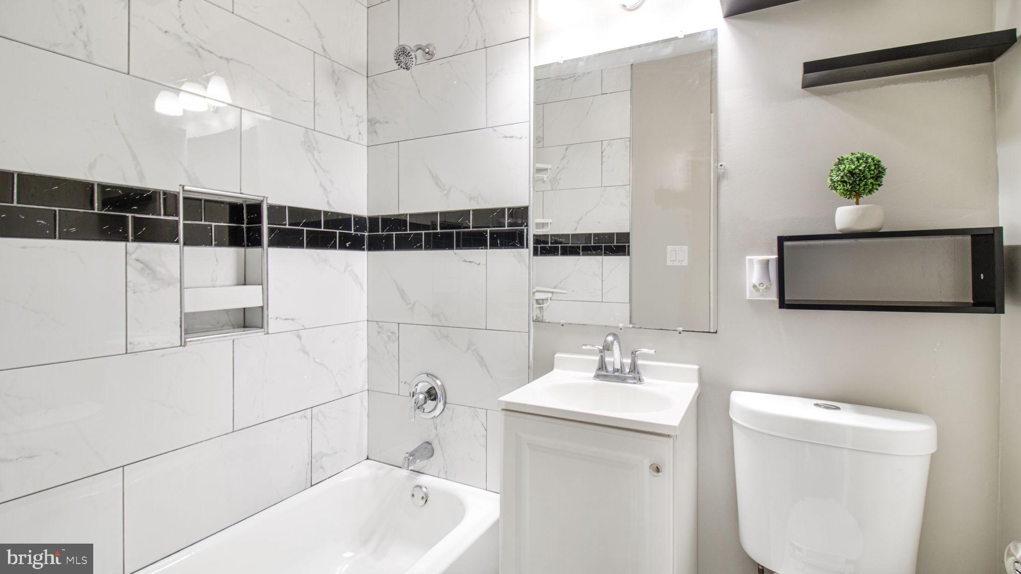 7600 Greenleaf Road Hyattsville, MD 20785 - Photo 30 of 42 a bathroom with a sink a toilet and shower