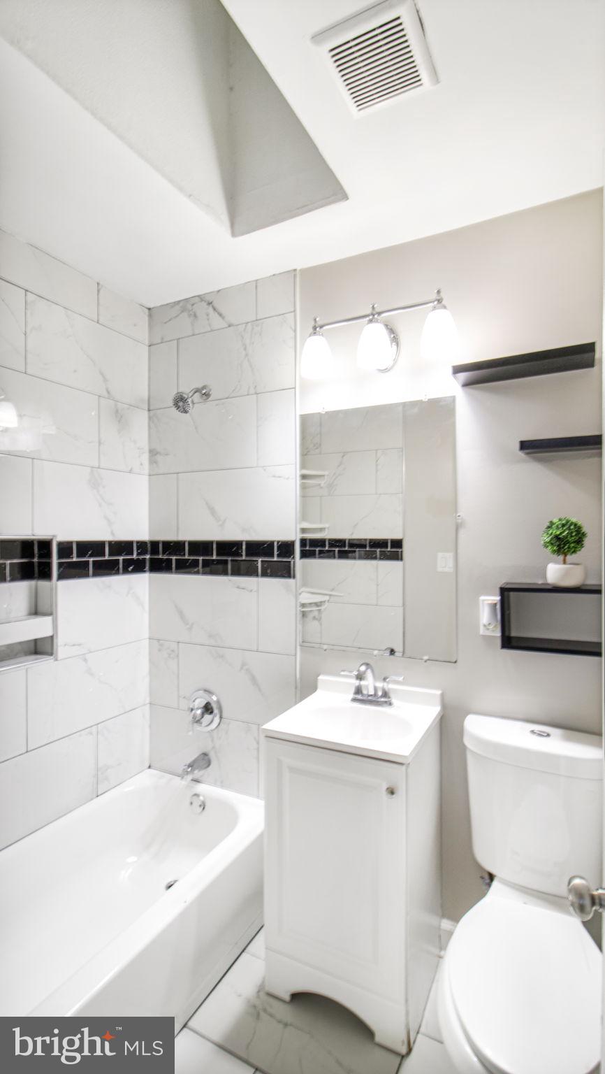 7600 Greenleaf Road Hyattsville, MD 20785 - Photo 31 of 42 a bathroom with a sink a toilet and shower