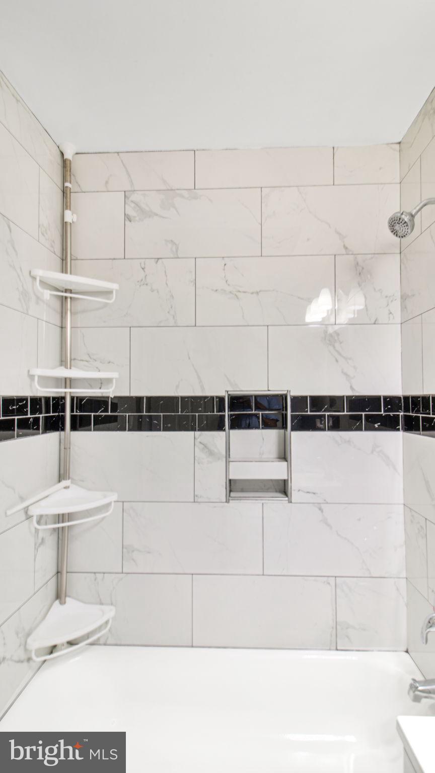 7600 Greenleaf Road Hyattsville, MD 20785 - Photo 32 of 42 a bathroom with a bathtub and shower