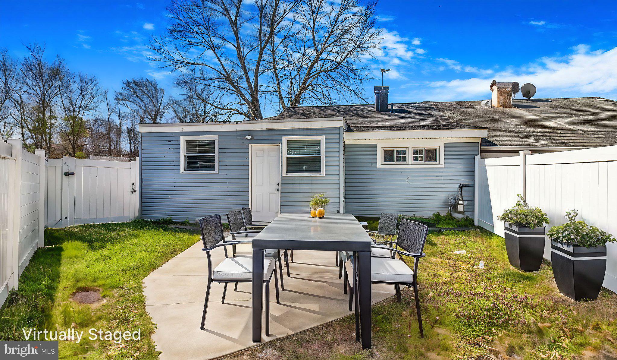 7600 Greenleaf Road Hyattsville, MD 20785 - Photo 36 of 42 a view of a patio with table and chairs and potted plants with wooden fence