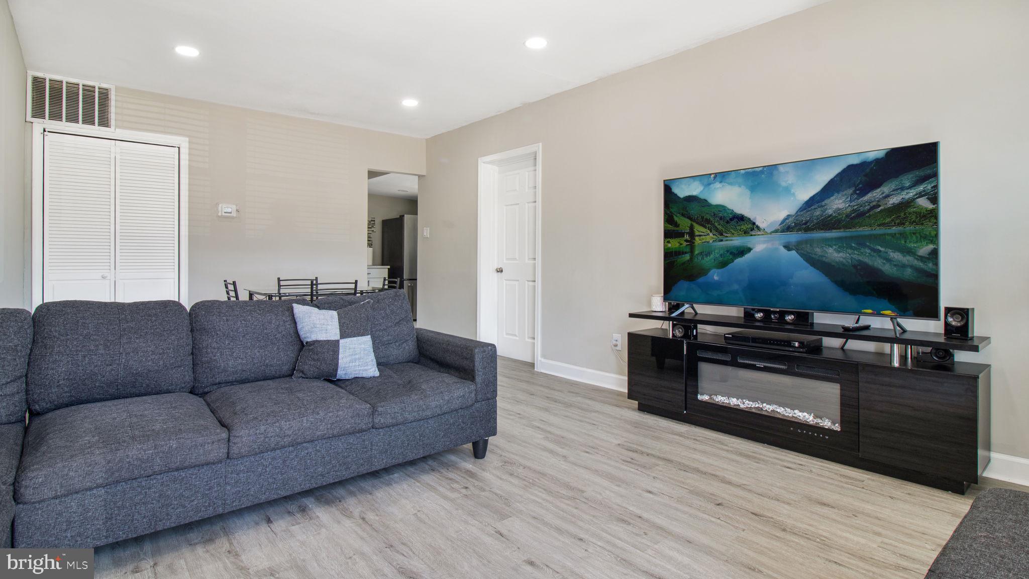 7600 Greenleaf Road Hyattsville, MD 20785 - Photo 5 of 42 a living room with furniture and a flat screen tv