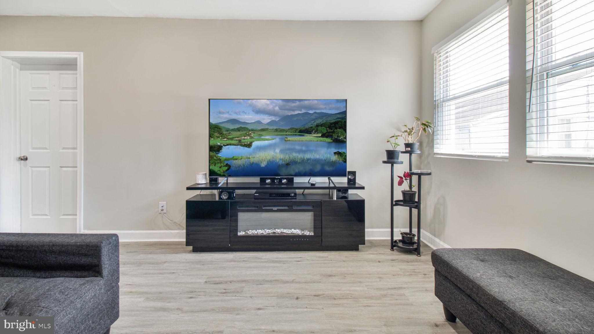 7600 Greenleaf Road Hyattsville, MD 20785 - Photo 7 of 42 a living room with furniture and a flat screen tv