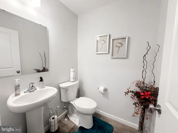 a bathroom with a sink toilet and a mirror