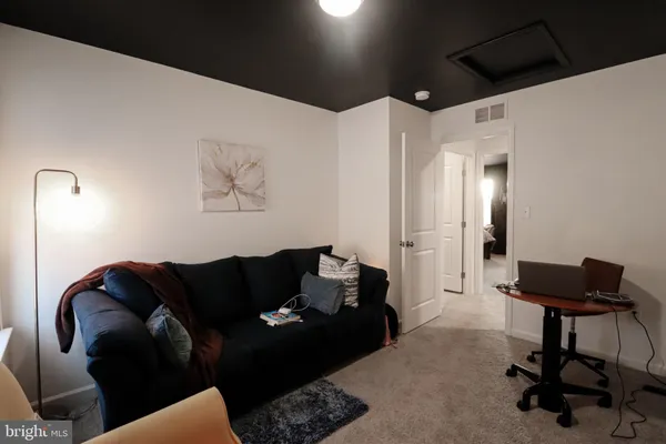 a living room with furniture and a mirror