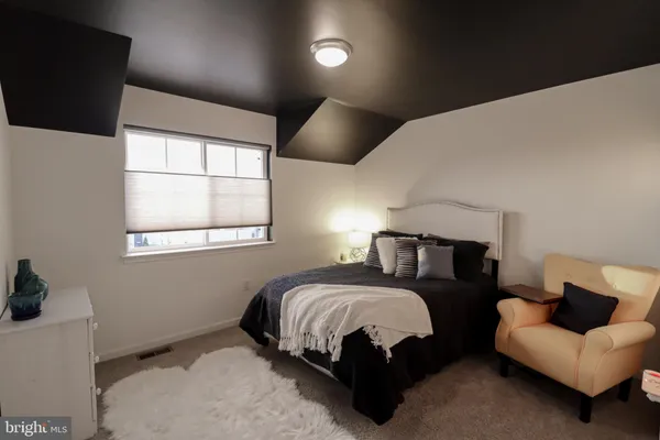 a bedroom with a bed and a couch