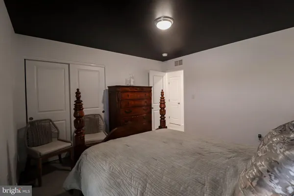 a bedroom with a bed and a dresser