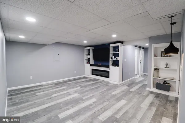 a view of a kitchen with a sink and dishwasher a refrigerator a fireplace