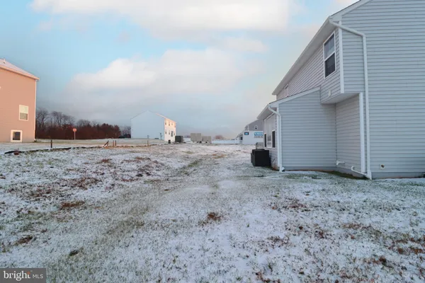 a view of a dry space in front of a house