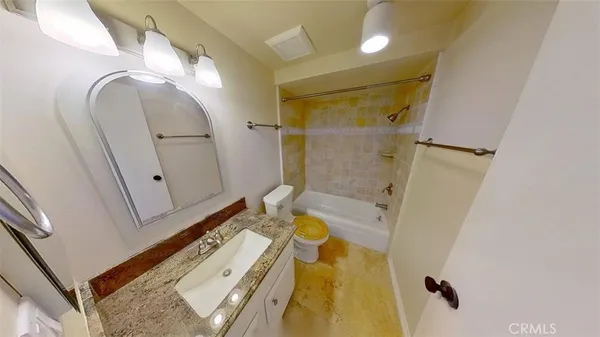 a bathroom with a tub a sink and glass door shower