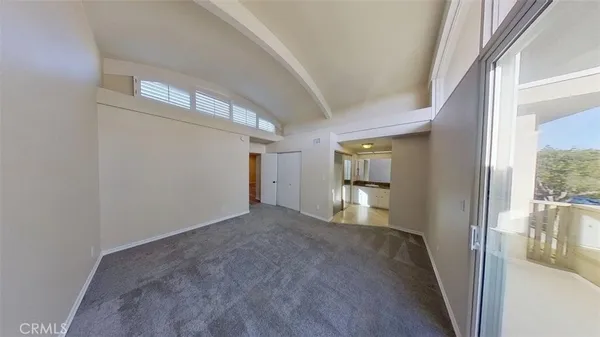 a view of a big room with wooden floor and windows