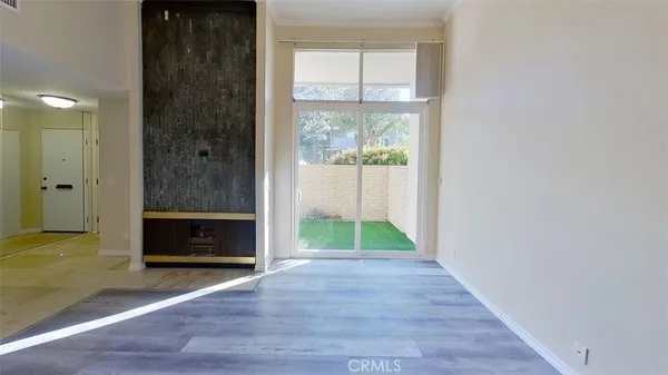a view of empty room with window and hardwood