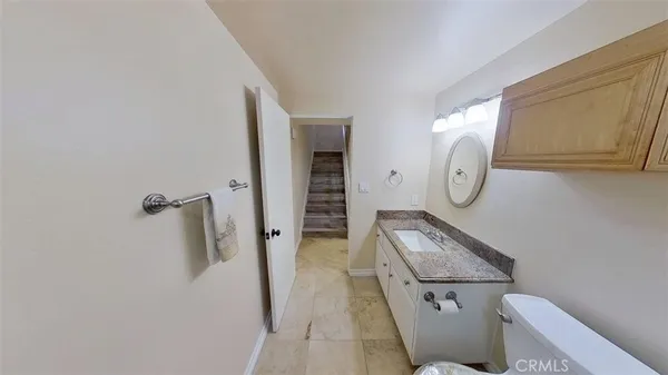 a view of bathroom with mirror toilet and a sink