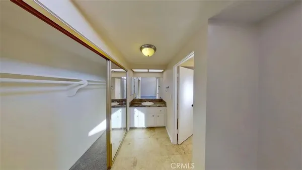 a bathroom with a granite countertop sink a toilet and shower