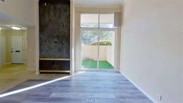 a view of empty room with window and hardwood