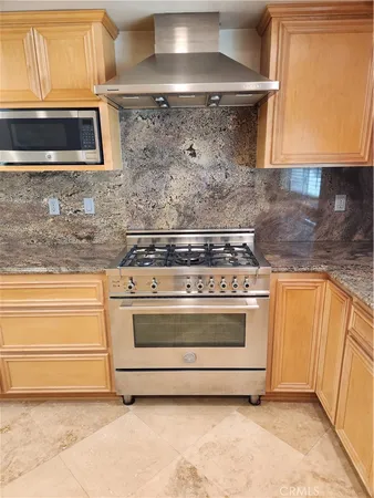 a stove top oven sitting inside of a kitchen