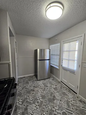 a kitchen with a refrigerator and a sink