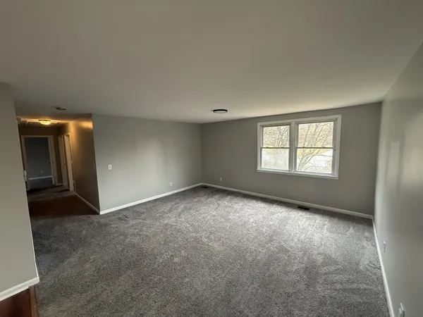 an empty room with windows and entrance