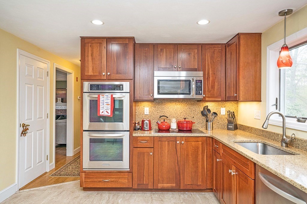 4 Gilmore Road Easton, MA 02356 - Photo 8 of 37 a kitchen with stainless steel appliances granite countertop wooden cabinets a sink and a refrigerator