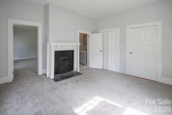 a view of a livingroom with an empty space and a fireplace
