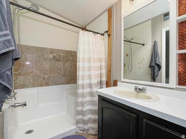 94 Spring Canyon Road Coalville, UT 84017 - Photo 45 of 50 Bathroom featuring a white bathtub and shower combination with stone-look tile surround