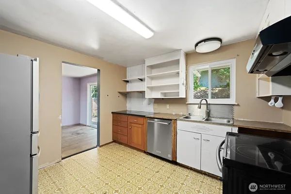 a kitchen with a sink stove and cabinets