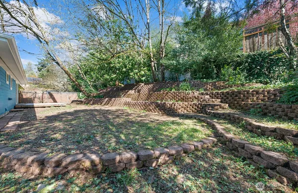 a backyard of a house with a yard and outdoor seating