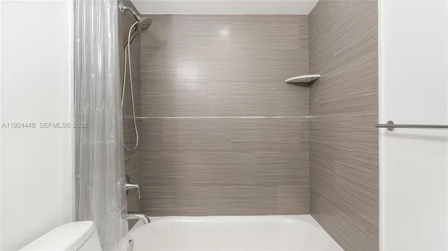 a bathroom with a shower and a toilet