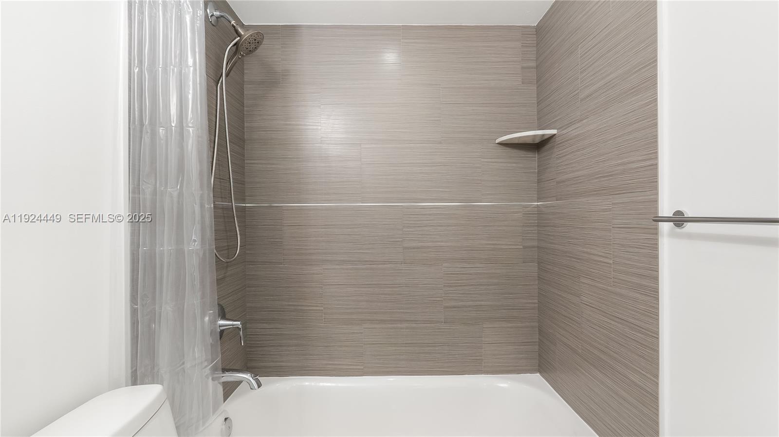 850 North Miami Avenue, Unit W1707 Miami, FL 33136 - Photo 15 of 35 a bathroom with a shower and a toilet