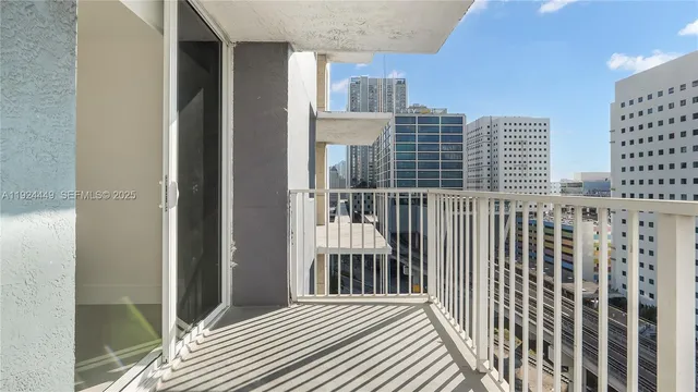 a view of a balcony with wooden floor and fence