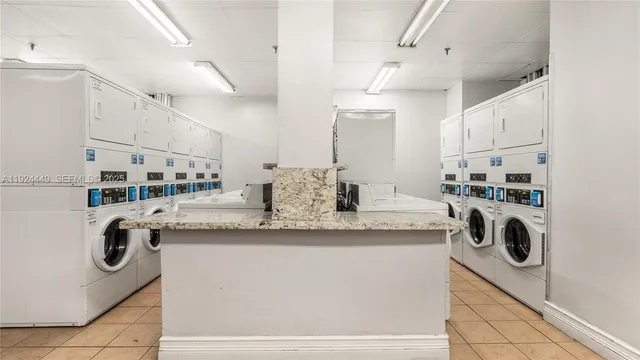 a kitchen with kitchen island a sink a stove and refrigerator